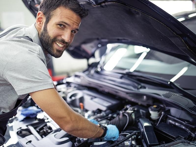 service technician working on the engine of a vehicle at Faulkner Hyundai Harrisburg in Harrisburg PA 