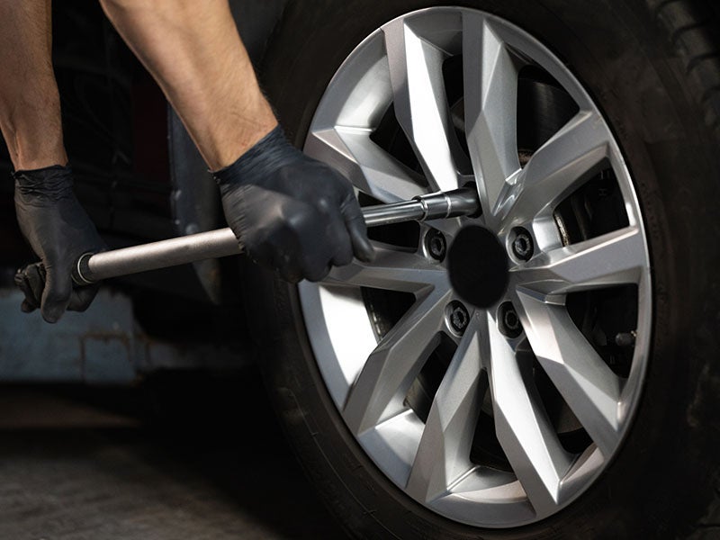 service technician changing a tire at Faulkner Hyundai Harrisburg in Harrisburg PA 